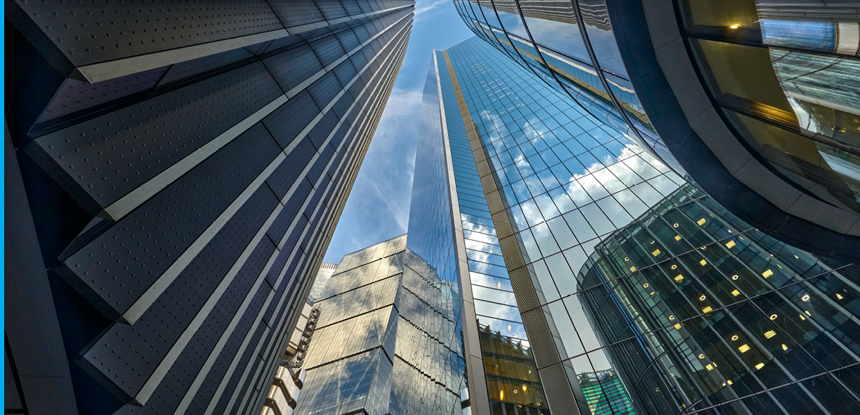Low angle view looking directly up from Lime Street to Lloyds of London Building, The Scalpel Building, St Andrew's Undershaft  and The Leadenhall Building in the City of London UK