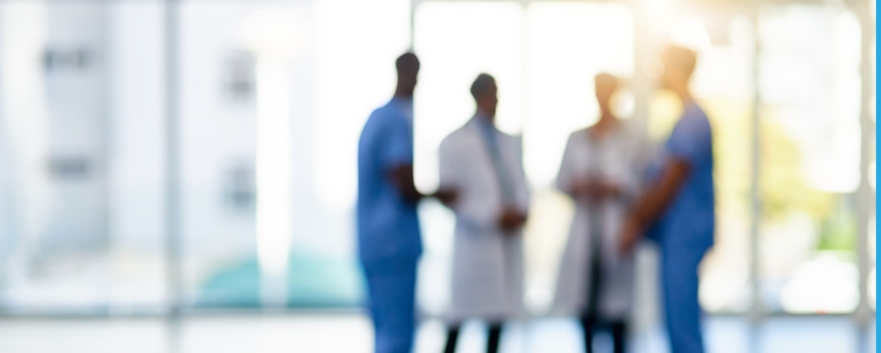 Blurred shot of a team of doctors standing together in a hospital